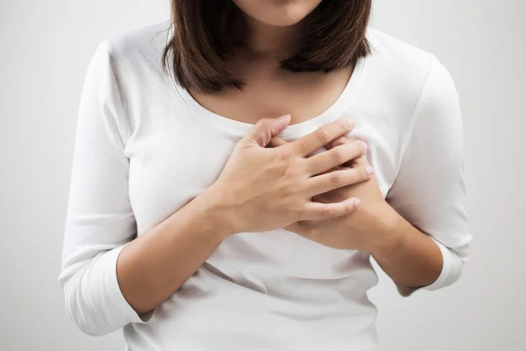 woman squeezes her breast
